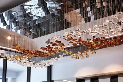 a chandelier hanging from a ceiling in a room at AC Hotel by Marriott Bridgewater in Bridgewater