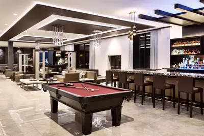 a billiard room with a pool table and a bar at AC Hotel by Marriott Bridgewater in Bridgewater