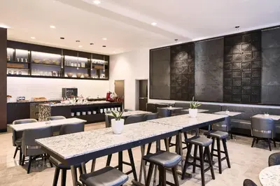 a restaurant with tables and chairs and a bar at AC Hotel by Marriott Bridgewater in Bridgewater