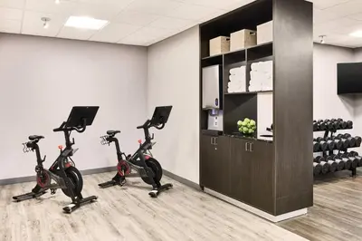 a gym with exercise bikes in a room at AC Hotel by Marriott Bridgewater in Bridgewater