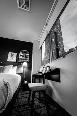a bedroom with a bed and a desk with a chair at U Hotel Fifth Avenue, Empire State Building in New York