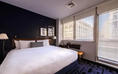a bedroom with a large white bed and two windows at U Hotel Fifth Avenue, Empire State Building in New York