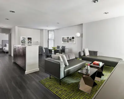 a living room with a couch and a table at AKA Times Square in New York