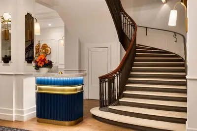 a spiral staircase in a lobby with a stair case at The Chemists Club Hotel in New York
