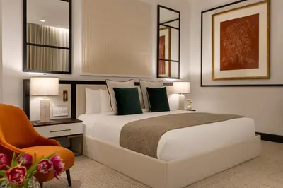 a bedroom with a large white bed and a chair at The Chemists Club Hotel in New York