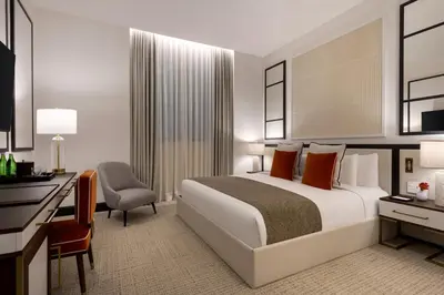 a hotel room with a bed and a desk at The Chemists Club Hotel in New York