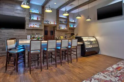a bar in a restaurant with chairs and a counter at Hampton Inn & Suites By Hilton- Newark Airport Elizabeth in Newark