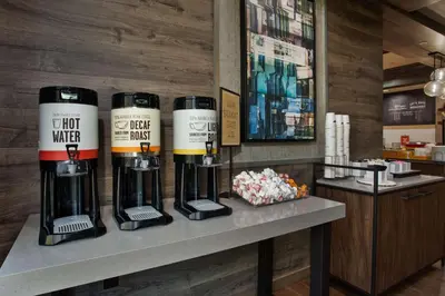 a counter with three wine bottles on it at Hampton Inn & Suites By Hilton- Newark Airport Elizabeth in Newark