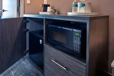 a microwave in a cabinet in a kitchen at Hampton Inn & Suites By Hilton- Newark Airport Elizabeth in Newark