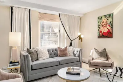 a living room with a couch and a chair at The Lexington Hotel, Autograph Collection in New York