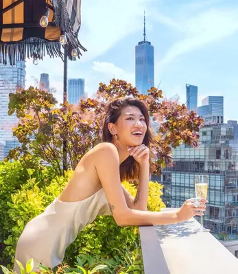 a woman sitting at a table with a glass of champagne at Soho Grand Hotel in New York