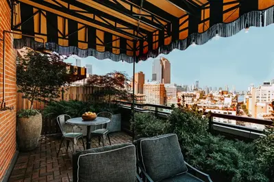 a patio with chairs and a table on a balcony at Soho Grand Hotel in New York