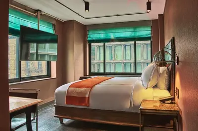 a bedroom with a large bed and a window at Soho Grand Hotel in New York