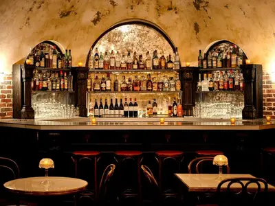 a bar with a lot of bottles of alcohol at Roxy Hotel New York in New York