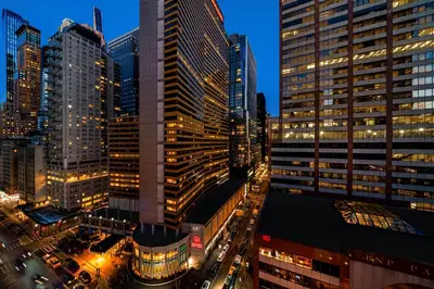 a city skyline at night with tall buildings at Sheraton New York Times Square Hotel in New York