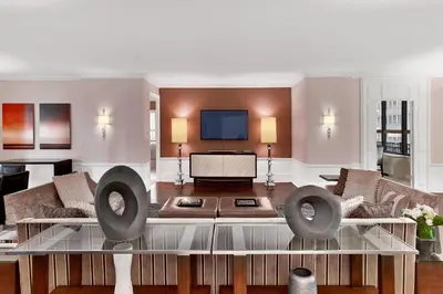 a living room with a couch and a tv at Sheraton New York Times Square Hotel in New York