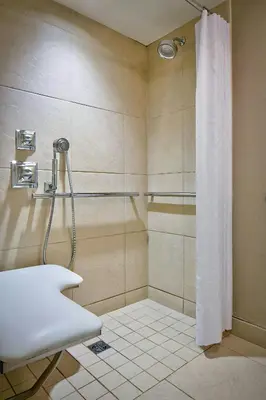 a bathroom with a shower with a shower curtain at Sheraton New York Times Square Hotel in New York
