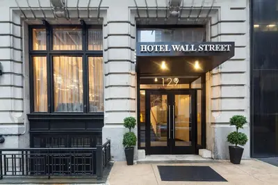 a hotel building with a hotel wall street sign on it at Eurostars Wall Street in New York