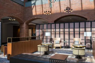 a lobby of a hotel with chairs and tables at Philadelphia Marriott Old City in Philadelphia