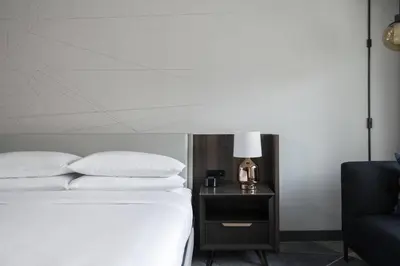 a bedroom with a bed and a night stand with a lamp at Philadelphia Marriott Old City in Philadelphia