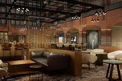 a lobby with a couch and tables and a bar at Philadelphia Marriott Old City in Philadelphia