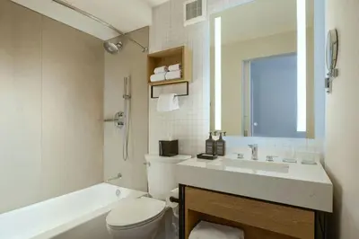 a bathroom with a toilet and a sink and a tub at Sheraton Philadelphia University City Hotel in Philadelphia