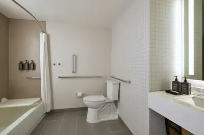 a bathroom with a toilet and a tub and a sink at Sheraton Philadelphia University City Hotel in Philadelphia