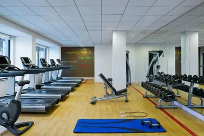 a gym with a row of tread machines at Sheraton Philadelphia University City Hotel in Philadelphia