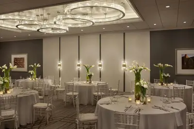 a room with white tables and chairs with white flowers at Sheraton Philadelphia University City Hotel in Philadelphia