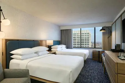 a hotel room with two beds and a window at Sheraton Philadelphia University City Hotel in Philadelphia