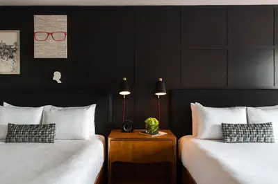 two beds in a hotel room with black walls at Renaissance Philadelphia Downtown Hotel in Philadelphia