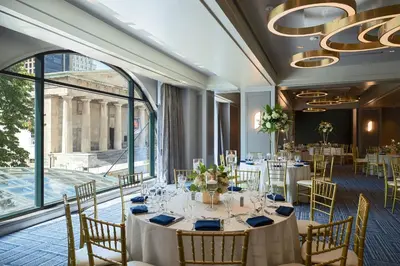 a dining room with tables and chairs and a large window at Renaissance Philadelphia Downtown Hotel in Philadelphia