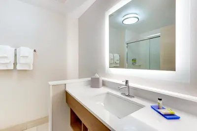 a white bathroom with a sink and a mirror at Holiday Inn Express & Suites - Middletown - Goshen by IHG in Middletown
