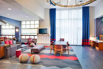 a living room with a tv and a table and chairs at Four Points by Sheraton Philadelphia Airport in Philadelphia