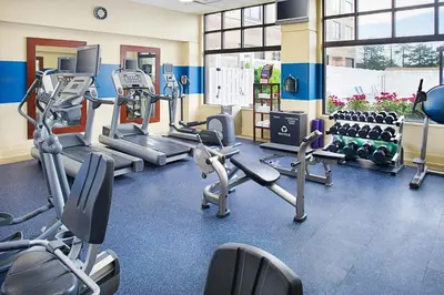 a gym with several treadmills and cardio machines at Four Points by Sheraton Philadelphia Airport in Philadelphia