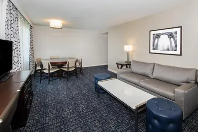 a living room with a couch and a table at Sheraton Suites Philadelphia Airport in Philadelphia