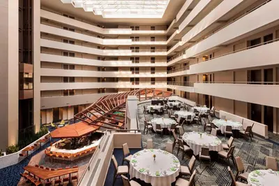 an indoor patio with tables and chairs in a building at Sheraton Suites Philadelphia Airport in Philadelphia