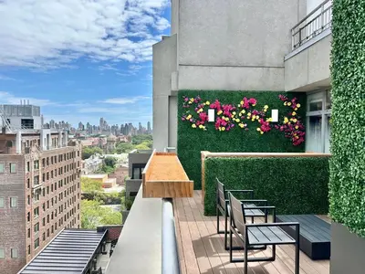 a balcony with chairs and flowers on a building at Arthouse Hotel in New York