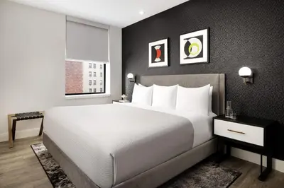 a bedroom with a large white bed and a window at Arthouse Hotel in New York