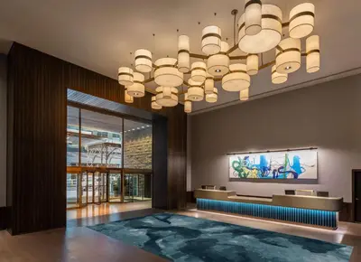 a large lobby with a large chandelier at Thompson Central Park New York, by Hyatt in New York