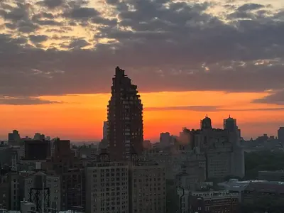 a city skyline at sunset with a tall building at Hotel Beacon in New York