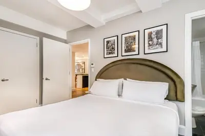 a bedroom with a large white bed with two pillows at Paramount Times Square - A Generator Hotel in New York