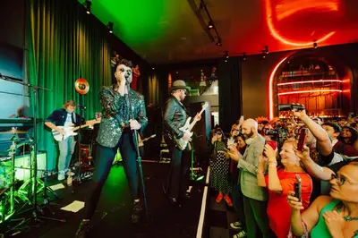 a band standing on a stage in front of a crowd at Paramount Times Square - A Generator Hotel in New York
