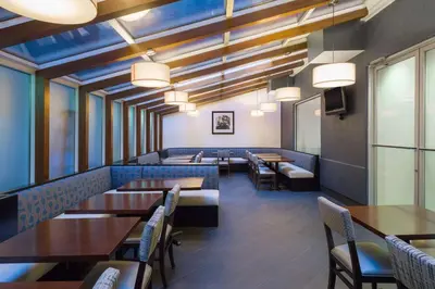a dining room with tables and chairs and lights at Hampton Inn Manhattan Chelsea in New York