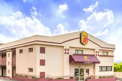 a fast food restaurant with a building with a sign at Super 8 by Wyndham North Bergen NJ/NYC Area in North Bergen