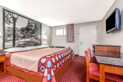 a hotel room with a bed and a desk at Super 8 by Wyndham North Bergen NJ/NYC Area in North Bergen