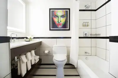 a bathroom with a white toilet and a sink at Park Central Hotel New York in New York