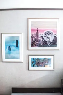 three framed pictures on a wall at Park Central Hotel New York in New York