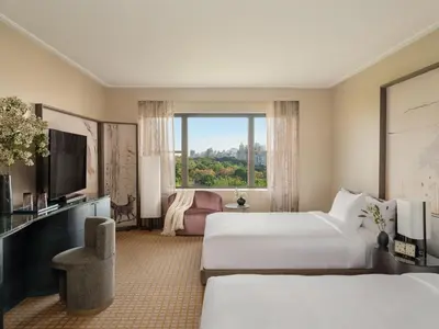 a hotel room with two beds and a flat screen tv at Park Lane New York in New York