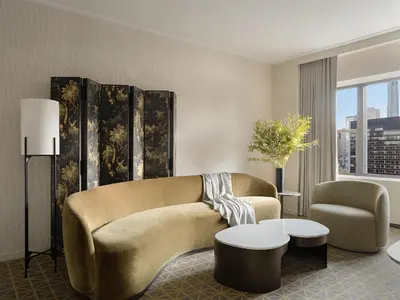 a living room with a couch and a table at Park Lane New York in New York